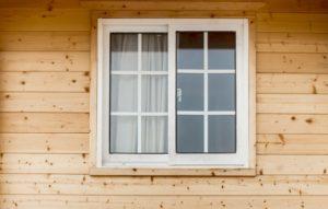 vinyl window on a house with wooden siding
