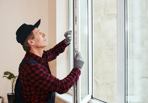 Worker adjusting window latch during Window Replacement in Glen Ellyn IL